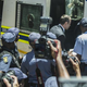 Oscar Pistorius (wearing suit), the double-amputee Olympic athlete, walks into a police van Oct. 21, 2014, under police escort in Pretoria, South Africa, after being sentenced in court there to five years in prison for killing his girlfriend, Reeva Steenkamp, on Valentine’s Day 2013.
MUJAHID SAFODIEN/AFP/Getty Images